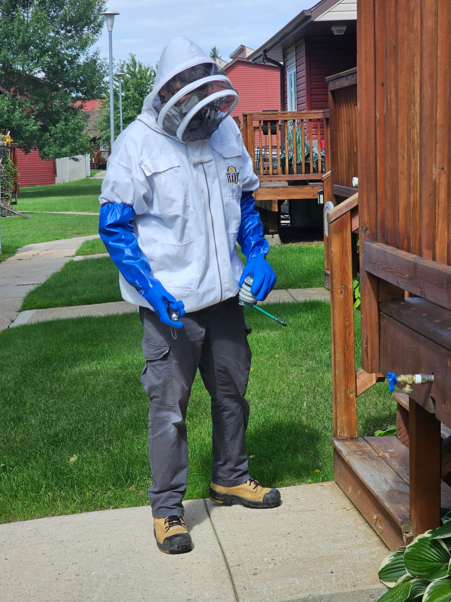 Pest control technician treating a residential property